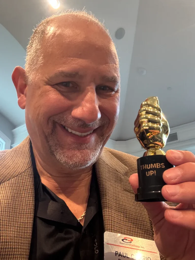 Paul Caprio with a thumbs up trophy